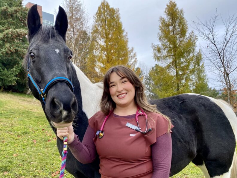 Anna Muszynski is show with a horse.
