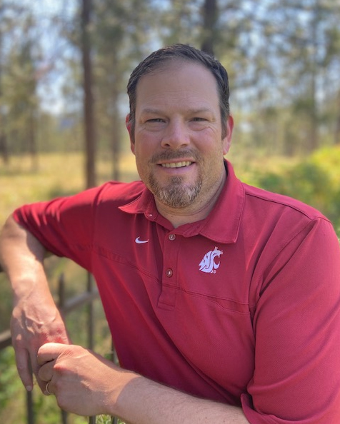 Casual photo of Luke. He's wearing a Coug branding shirt.