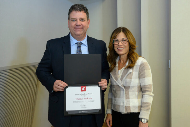 Thomas Waltzek (L), is given the Catalyst Award by WSU Vice President for Research Kim Christen (R).