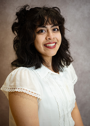 Jimena sitting for a portrait in a photo studio.