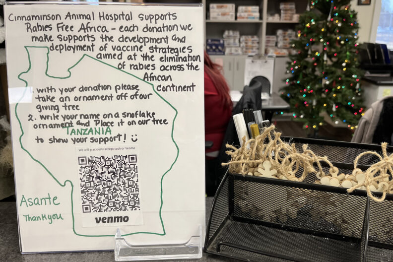 Photo of the sign on the counter at Cinnaminson Animal Hospital. It explains how to put an ornament on the tree after you donate.