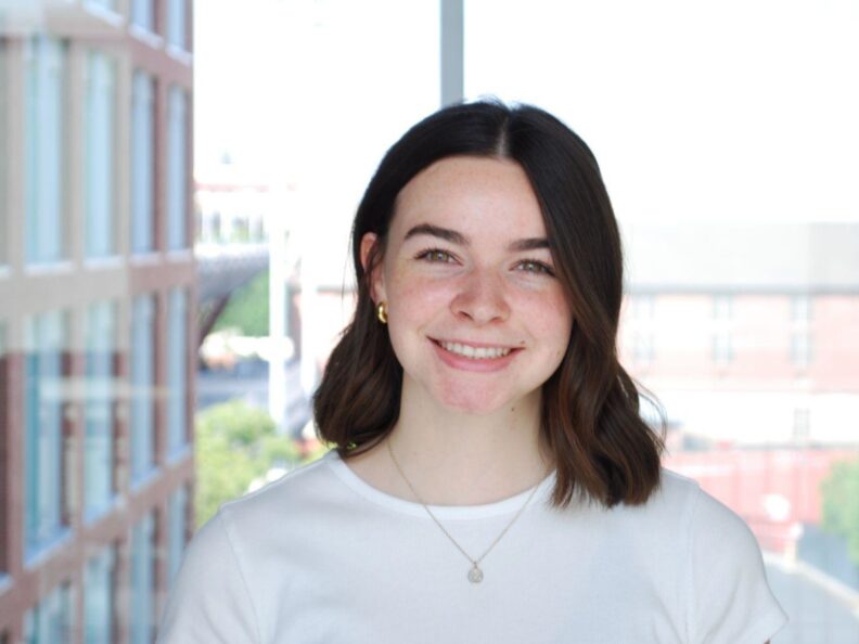 Taylor Page poses in front of a window.