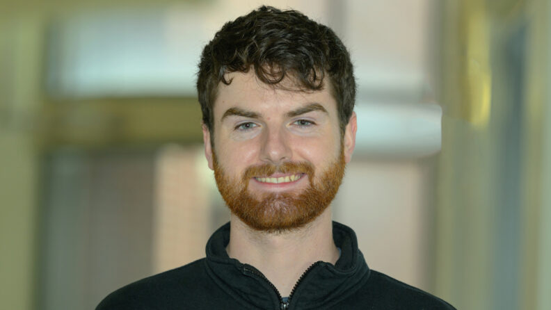 Professional headshot of Trent.