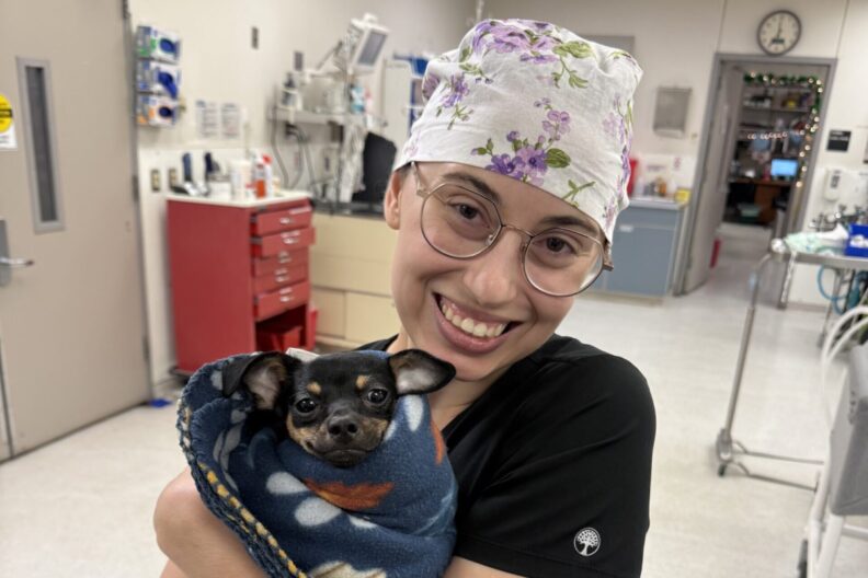 Genevea Rossman holds a small dog.