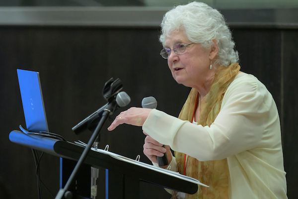 Pamela speaking from the podium.