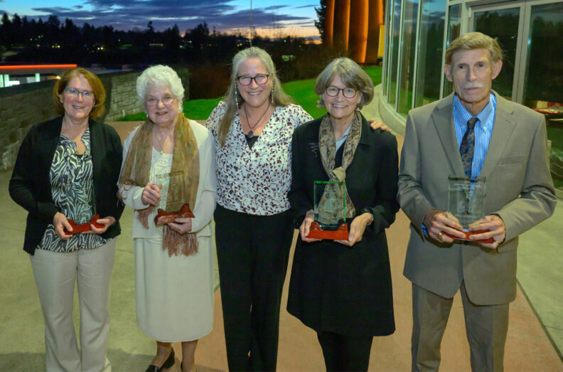 L-R Rena Carlson, Pamela Tuomi, Dori Borjesson, Julia Oxford, and Robert Olds outside the Multicultural Center, with the sunset in the background.