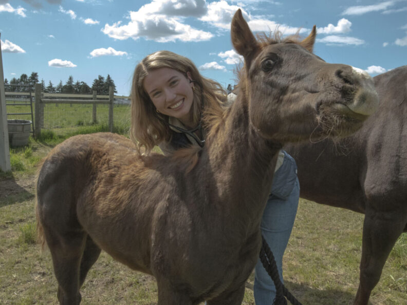 Emma Atkinson poses with a foal.