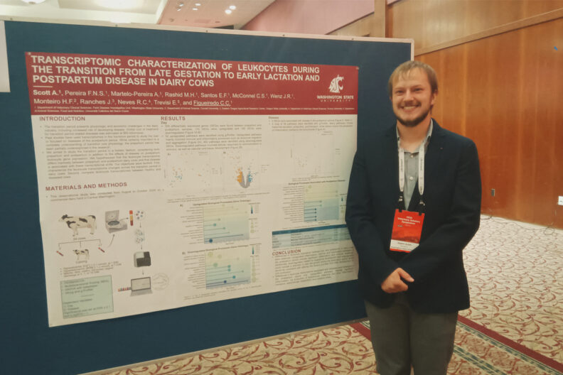 Aspen, standing next to his research poster.