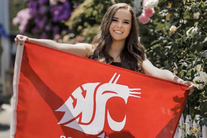 Hannah Fabacher holds a WSU flag.