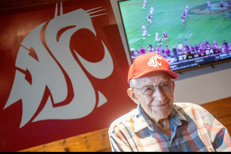 Jack, at Zeppoz's in Pullman, with a Cougar flag on the wall behind him.