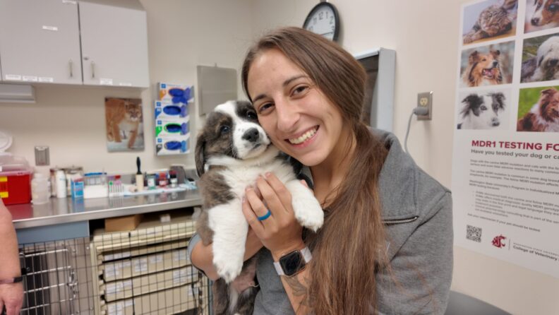 Jade Vollmer holds a puppy.
