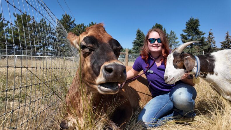 Elizabeth Worley poses with a cow and goat.