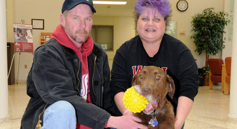 Owners Kurt and Sarah Weidner with Chocolate and his favorite yellow ball.