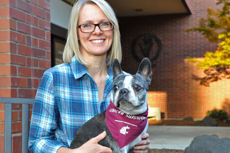 Portrait of Tami and Lucy. Lucy is wearing a Cancer Survivor scarf.