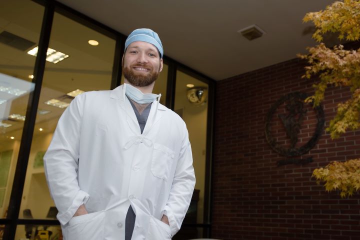 Christopher standing outside the Veterinary Teaching Hospital.