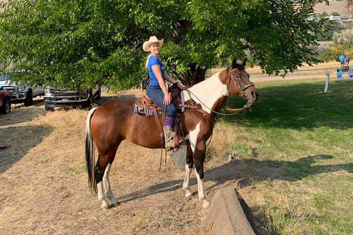 Cynthia on her horse, a brown and white paint.
