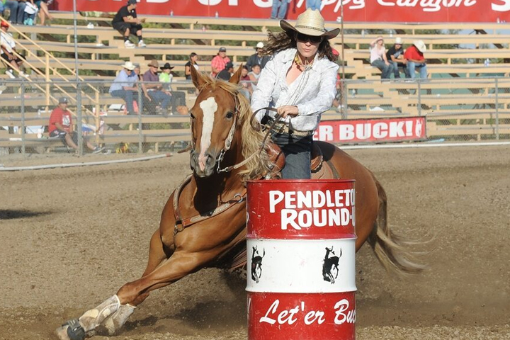 Jillian Connolly riding Sugar in a barrel race.