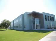 Exterior of a two-story building with a lawn outside.