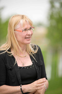 Birgit Ahring talking outside wearing a black shirt.