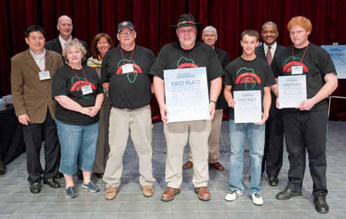 Group of people posing with awards.