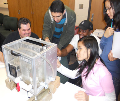 Five students looking at a desktop learning module.