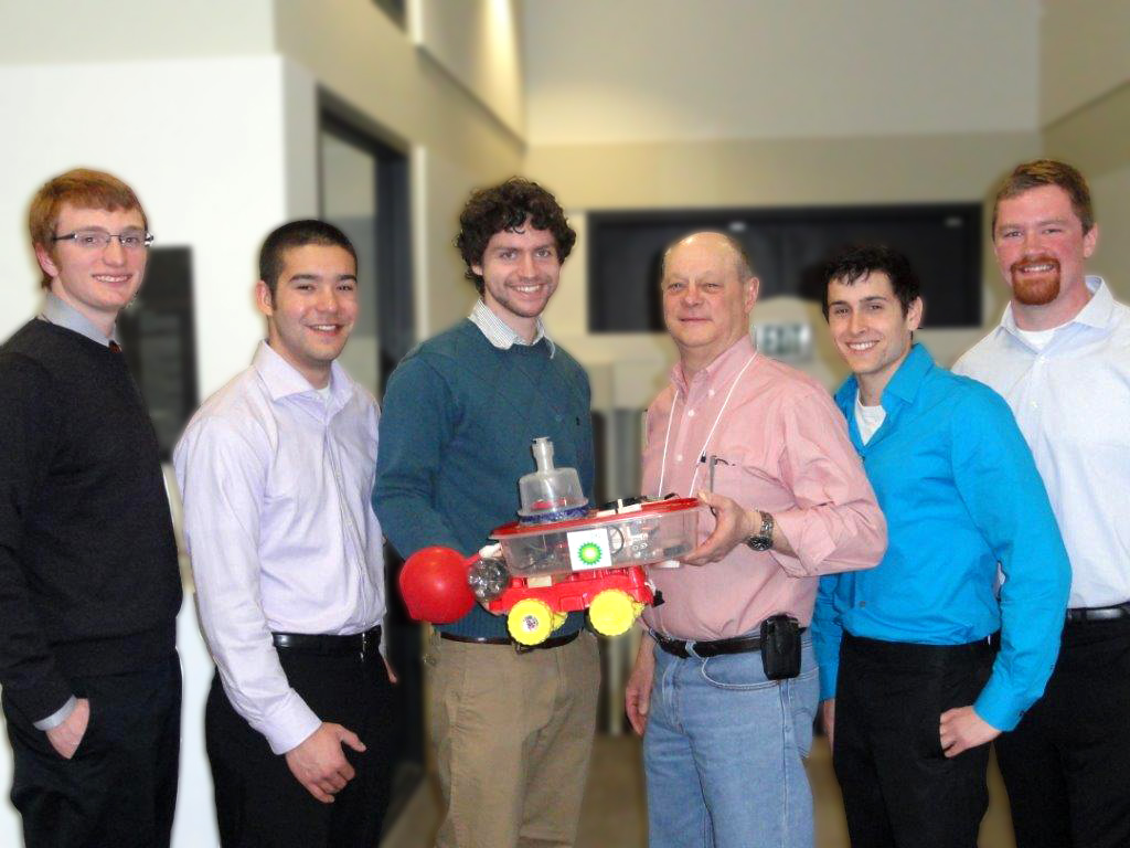 Six men posing with their chemically powered car.