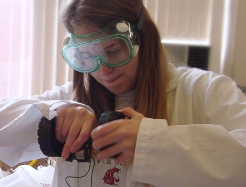 Student working with equipment in a lab.
