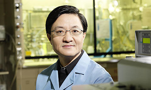 Yong Wang in a lab wearing a blue coat.