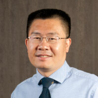 Hongfei Lin wearing glasses and a tie.