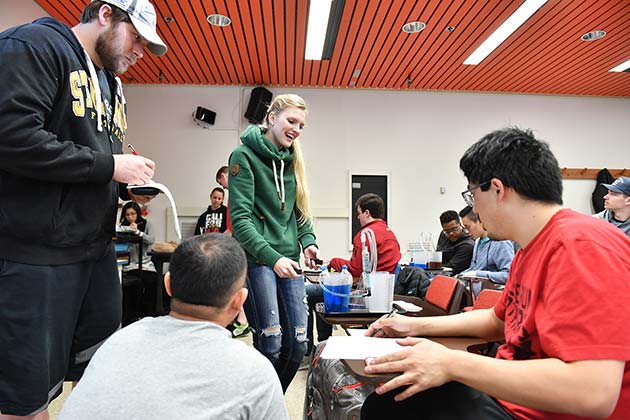 Students in a classroom performing various experiments.