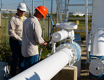 two men measuring methane.