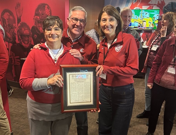 Rep. McMorris Rodgers poses next to WSU President Kirk Schulz and his wife Noel Schulz while holding a framed copy of the president's Congressional Record honoring his retirement.