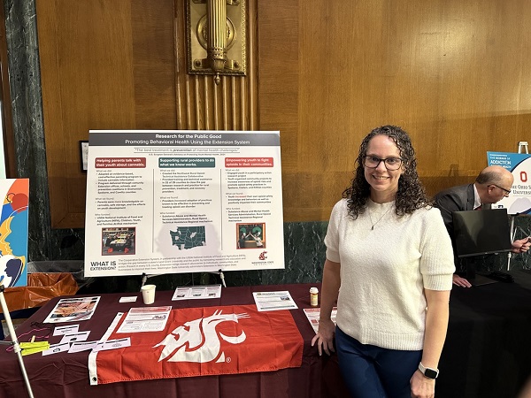Elizabeth Weybright stands before her poster presentation on Research for the Public Good. 