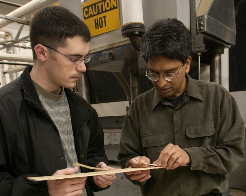 Vik Yadama inspects wood composites with his student