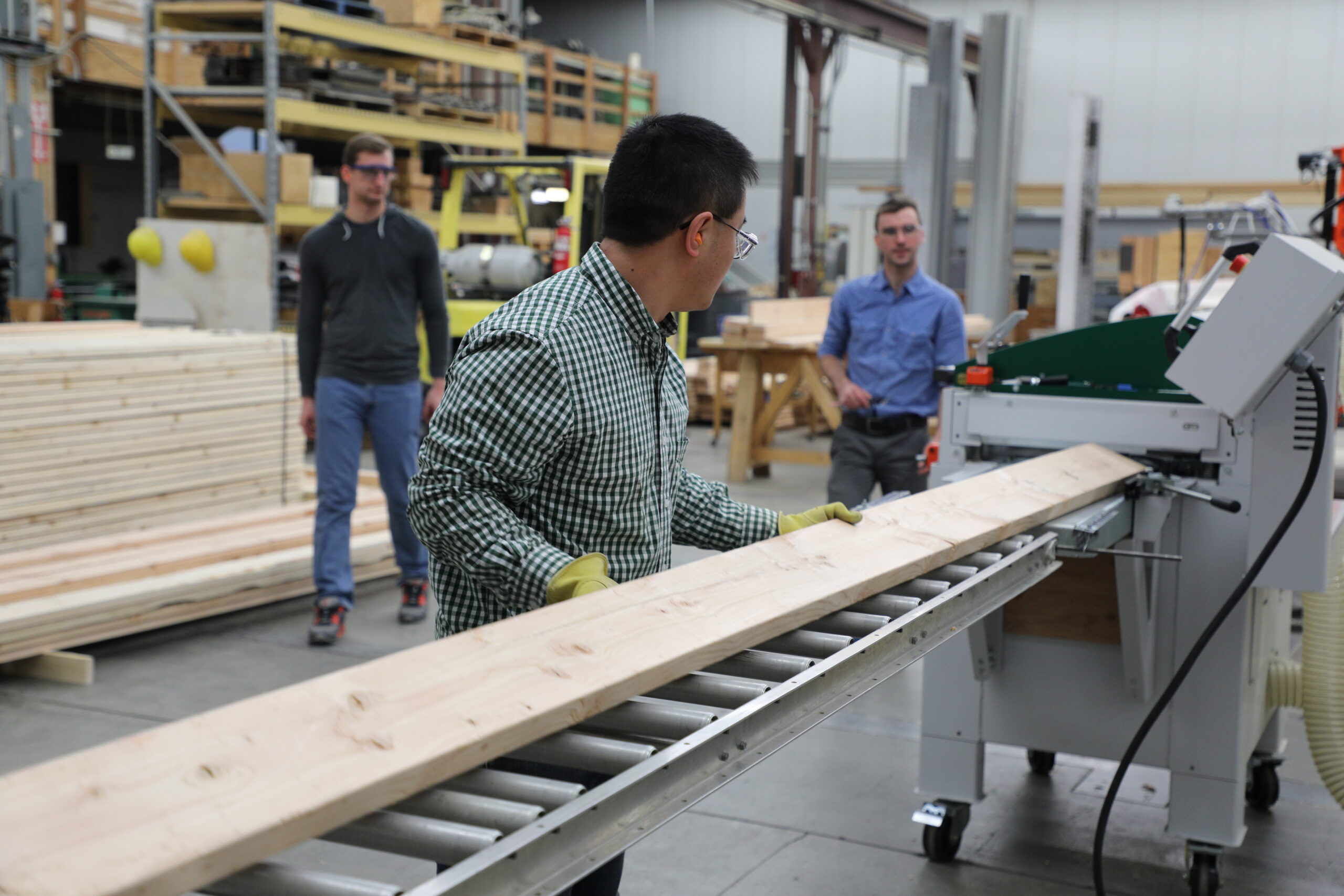Hui Li prepares lumber for CLT production