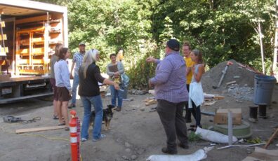 Group of people in a loose circle in a construction area