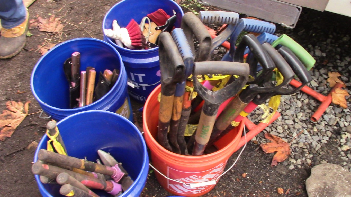 Photo of buckets of hand tools to use in the rain garden