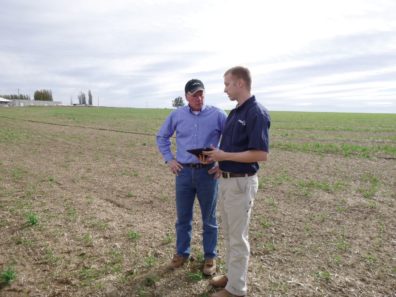 Patrick Williams consults onion farmer. 