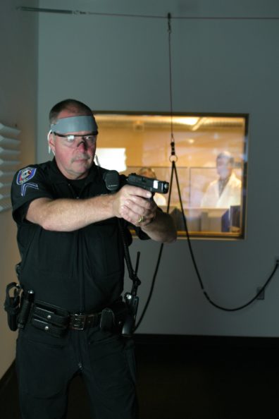 The officer is participating in a "use of force" simulation.