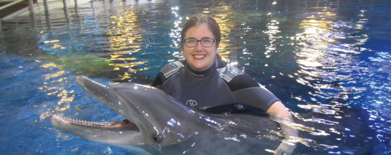 Kathleen Sullivan in pool with dolphin