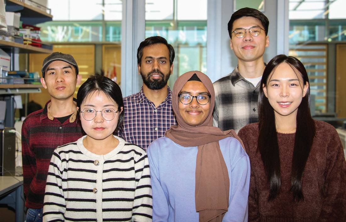 Six students pose for photo in the lab