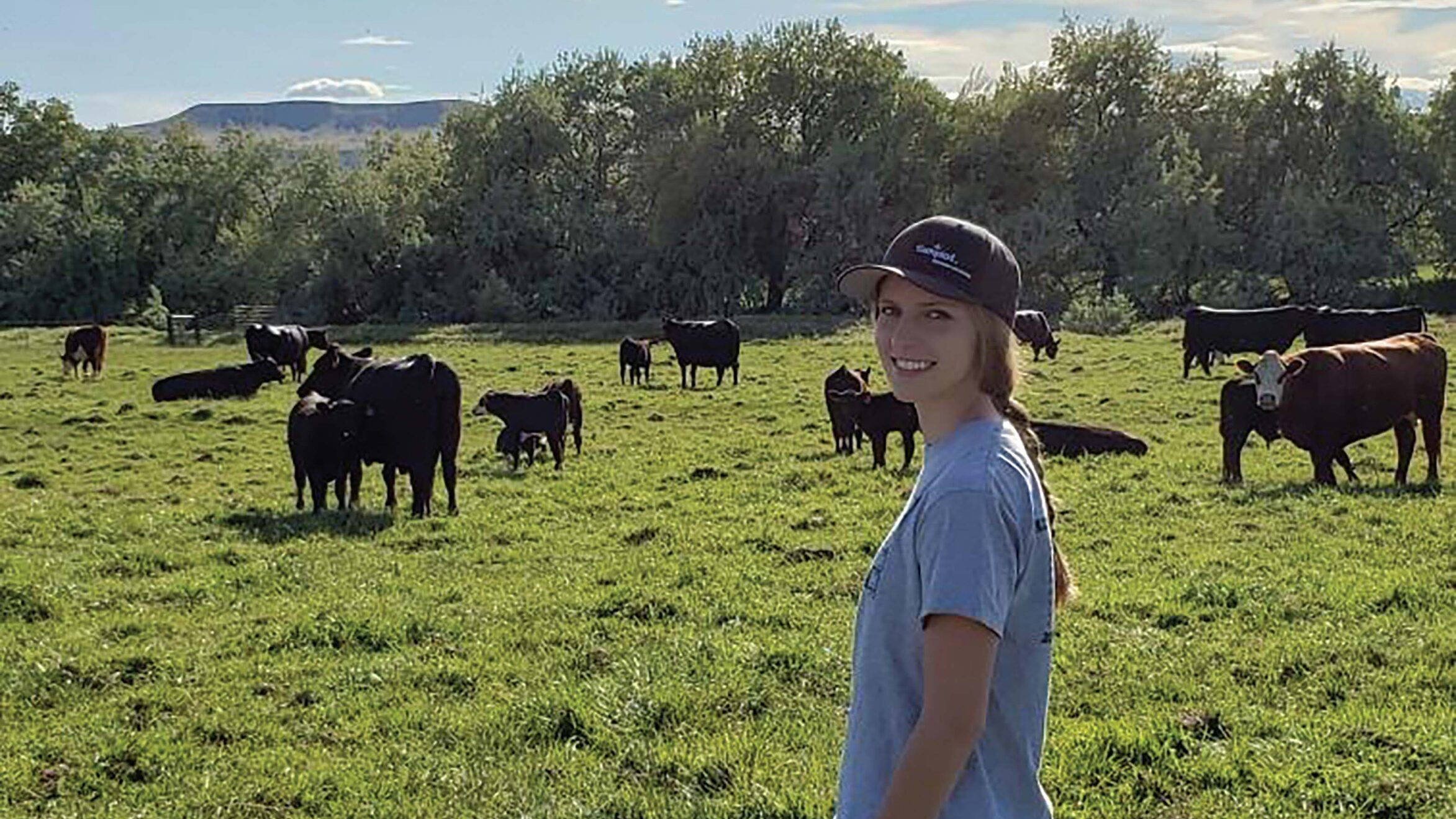 Katie Shira with cattle in background