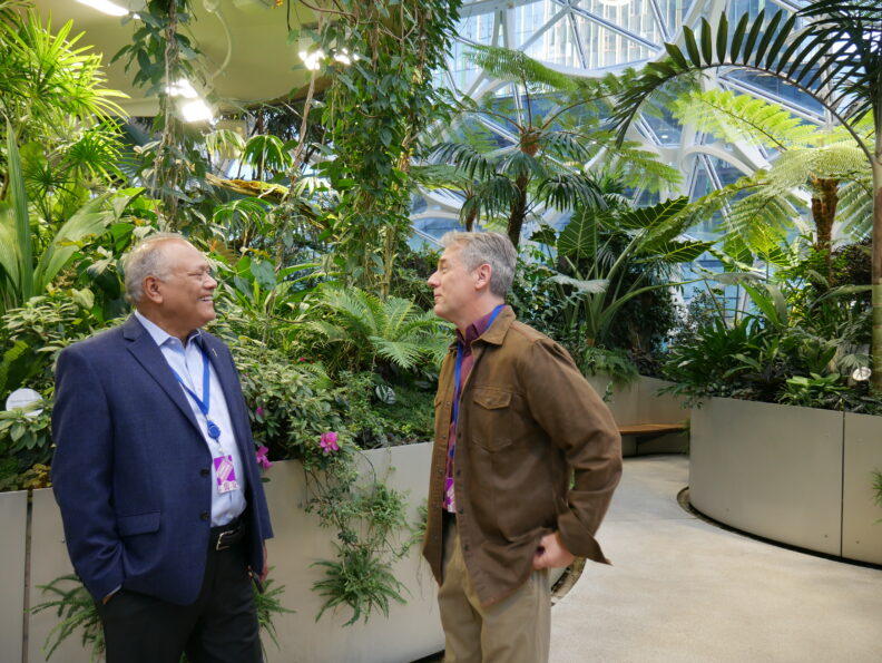 Two people talking inside the Amazon Spheres.