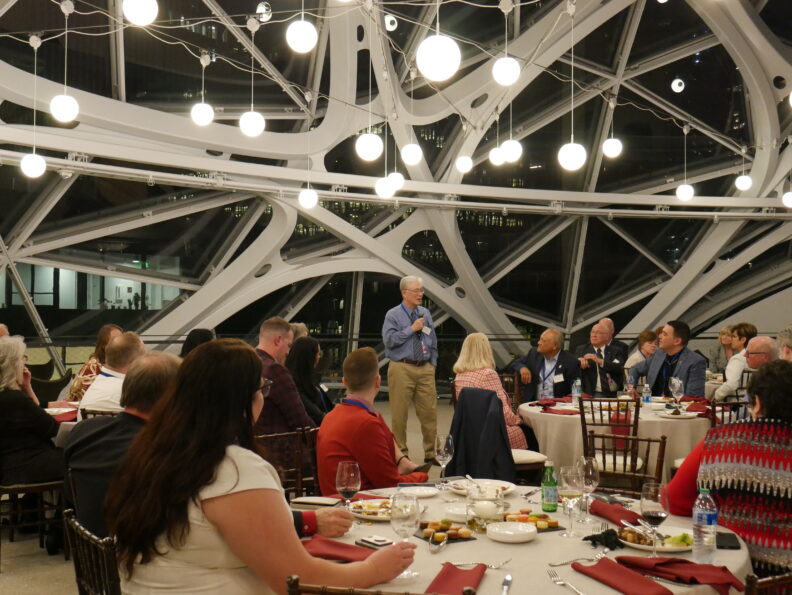 A former Regent gives speech to group inside the Amazon Spheres.