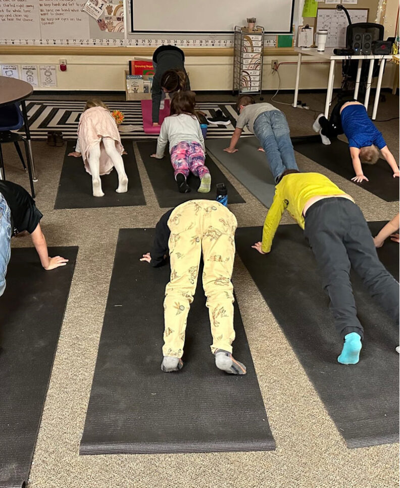 Kids doing yoga in classroom