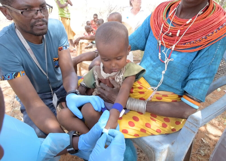 Kariuki Njenga working with doctors