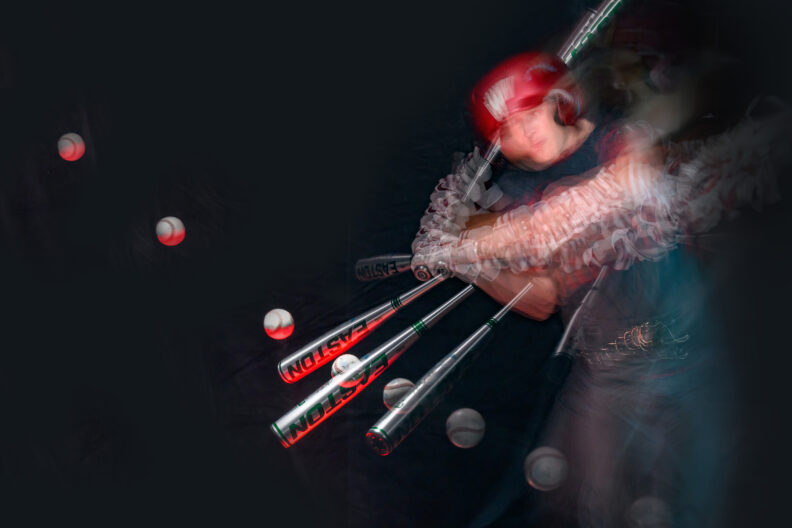 A sequence of shots overlaid to show a baseball player swinging a bats and the path of the baseball. 