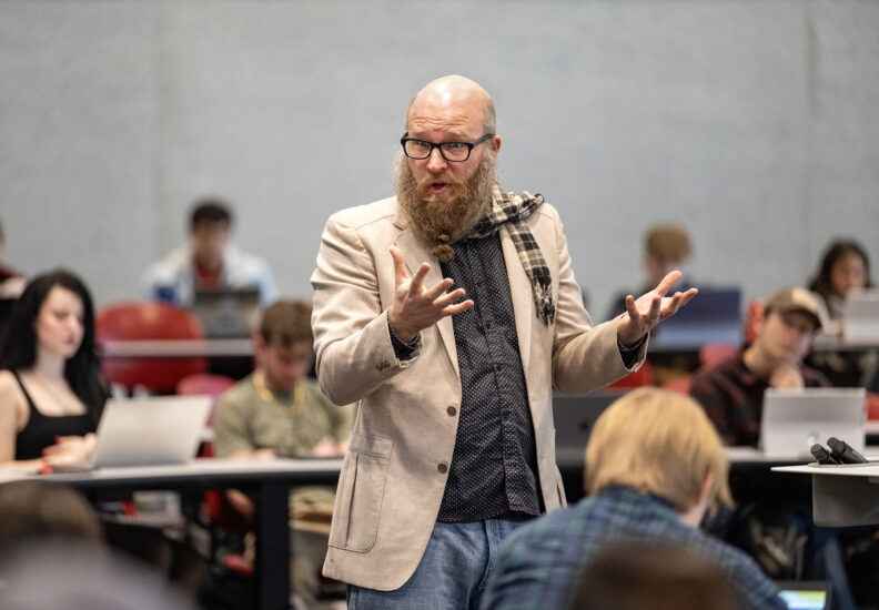 Clarke teaching in a classroom.