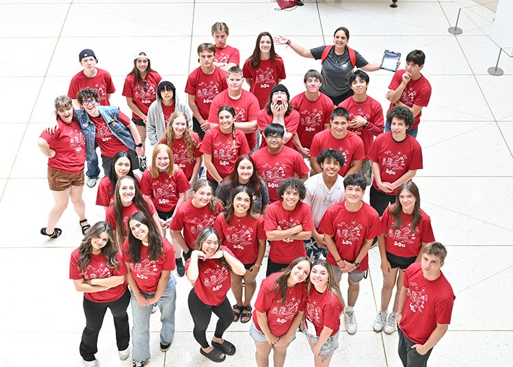 An orientation group and their OL smile up at the camera.