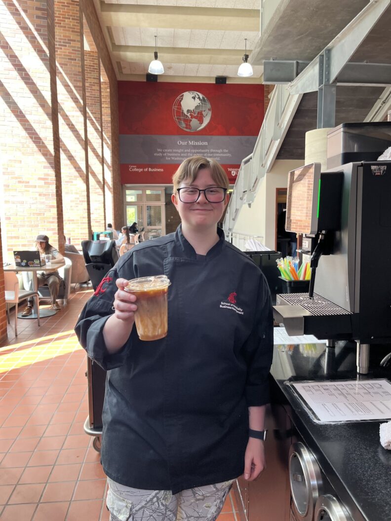 OL Ashlyn holds up a coffee as if to cheers you